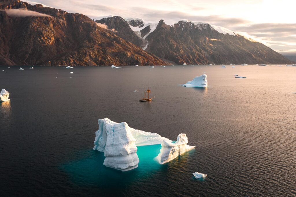 Schooner Opal sailing in Greenland during sunset